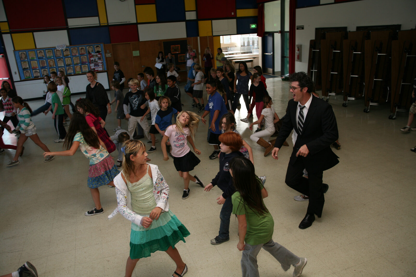 Daniel dancing with a full room of students
