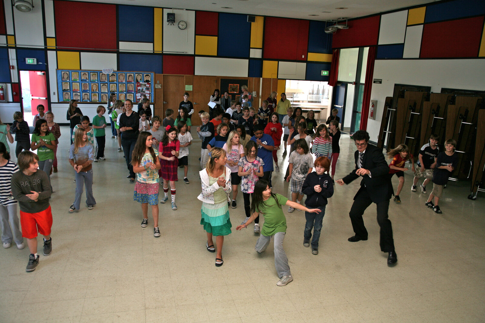 Students dancing across a school hall