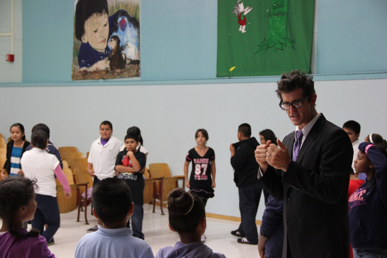 Daniel teaching students in a gym