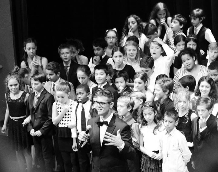 Daniel on stage with students